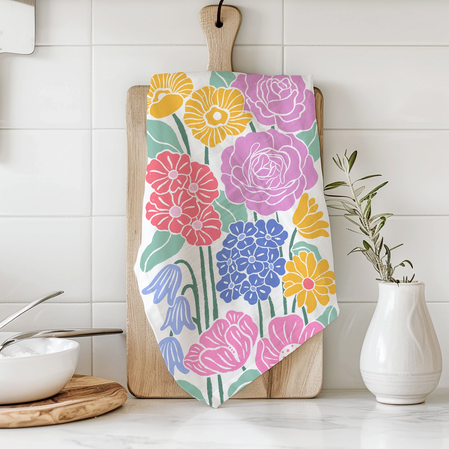 Styled photograph of a cotton kitchen towel with a floral print