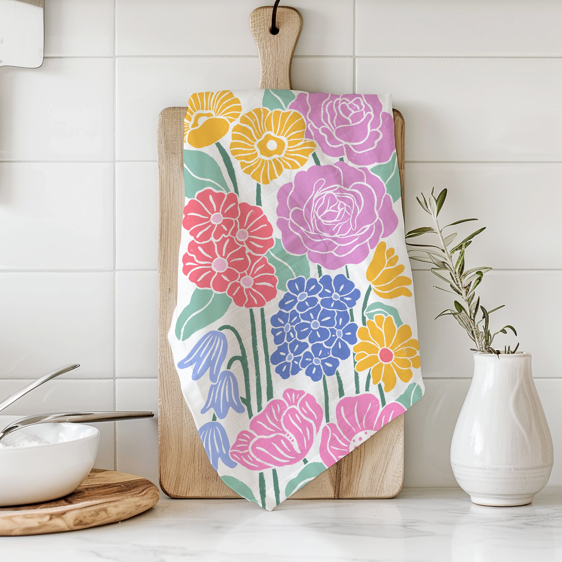 Styled photograph of a cotton kitchen towel with a floral print