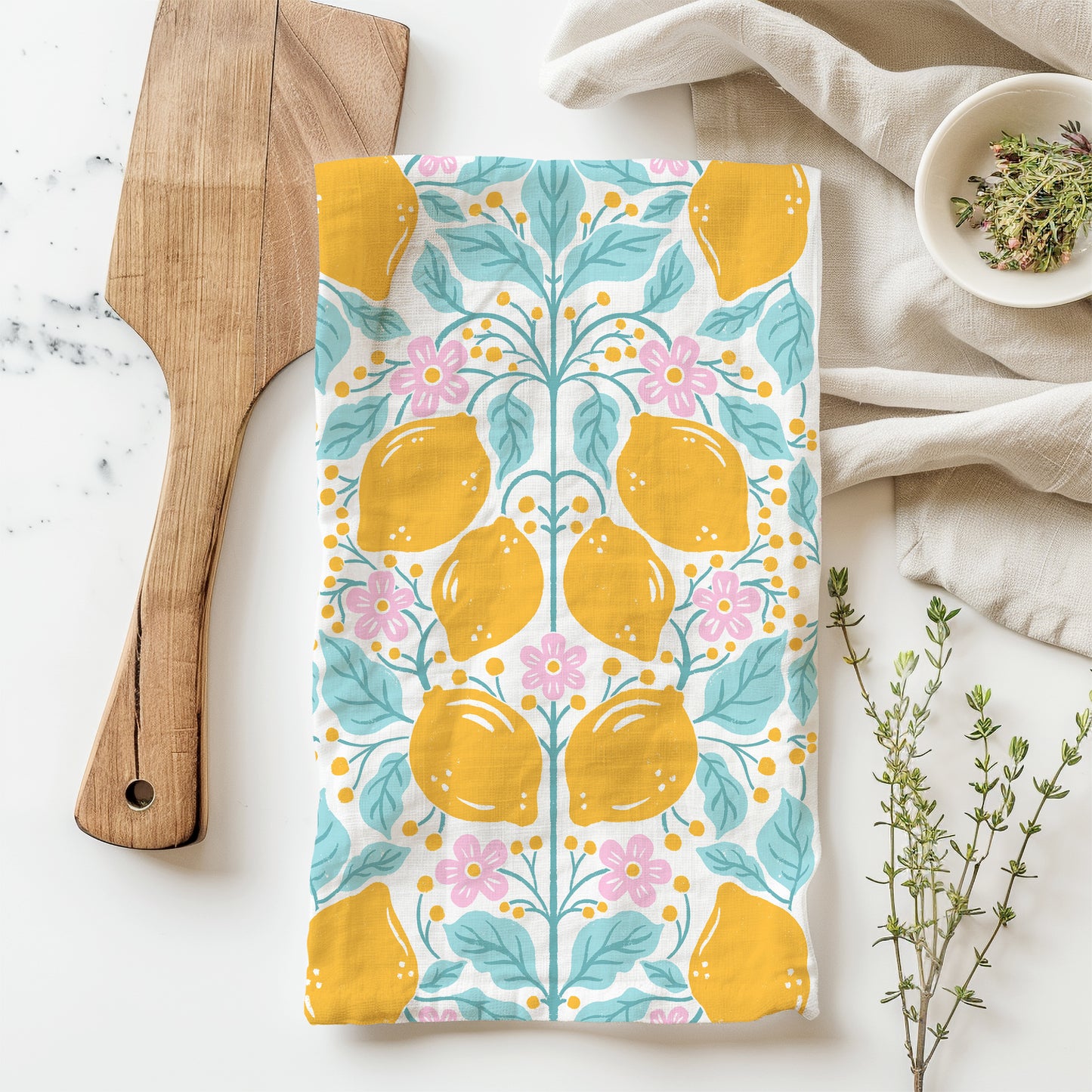 A styled flatlay of a cotton tea towel with a Folksy Lemon Print